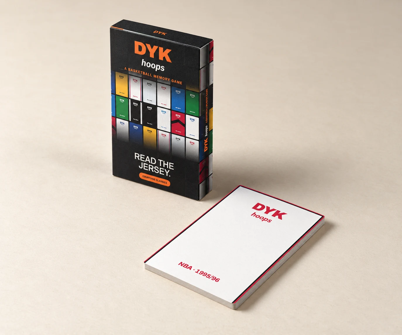DYK hoops Courtside Classics box beside a stack of jersey cards, with the white and red 1995/96 card on top.